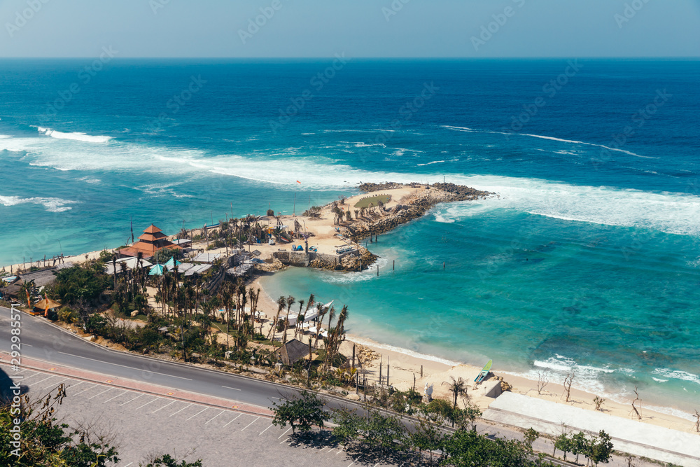 Beautiful view of Melasti Beach. Blue sea with waves, clear sky and white sand in Indian Ocean, South Kuta, Bali.