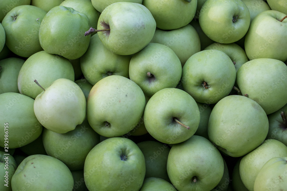 A box of green apples for sale at a market A box of green apples for sale at a market