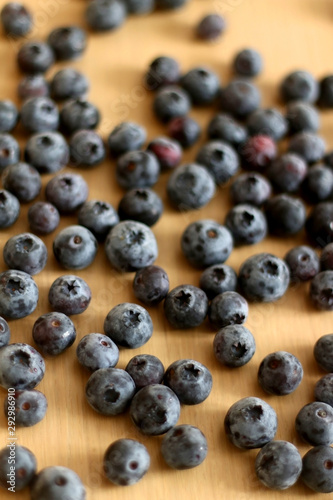 Pile of blueberries on a wooden table. Selective focus.