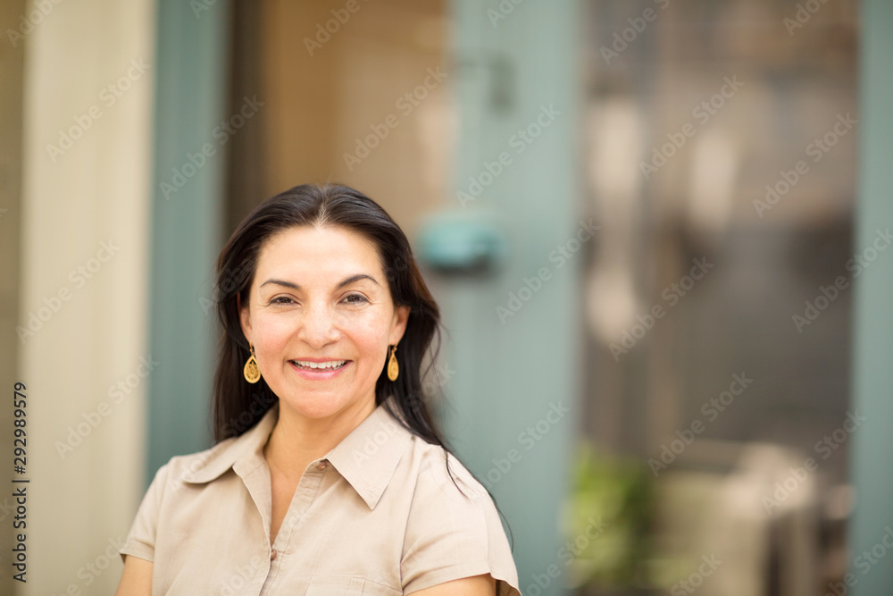 Happy Hispanic woman smiling and standing outside. Happy Hispanic woman smiling and standing outside.