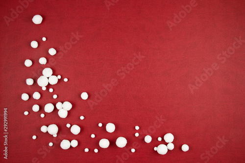 White snow balls over the red background © netrun78