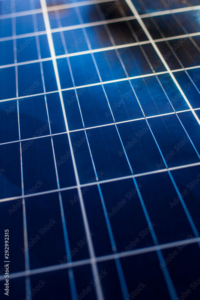 Surface of blue shiny solar photo voltaic panels. Producing clean energy. 