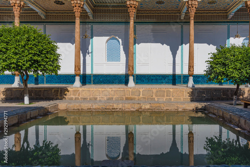 Inner courtyard with wooden columns and water reflection in the bahauddin naqshbandi memorial complex bukhara photo