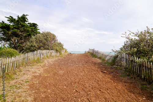 Fototapeta Naklejka Na Ścianę i Meble -  Fenced wood way to the beach in Saint Vincent sur Jard pathway access sea sand