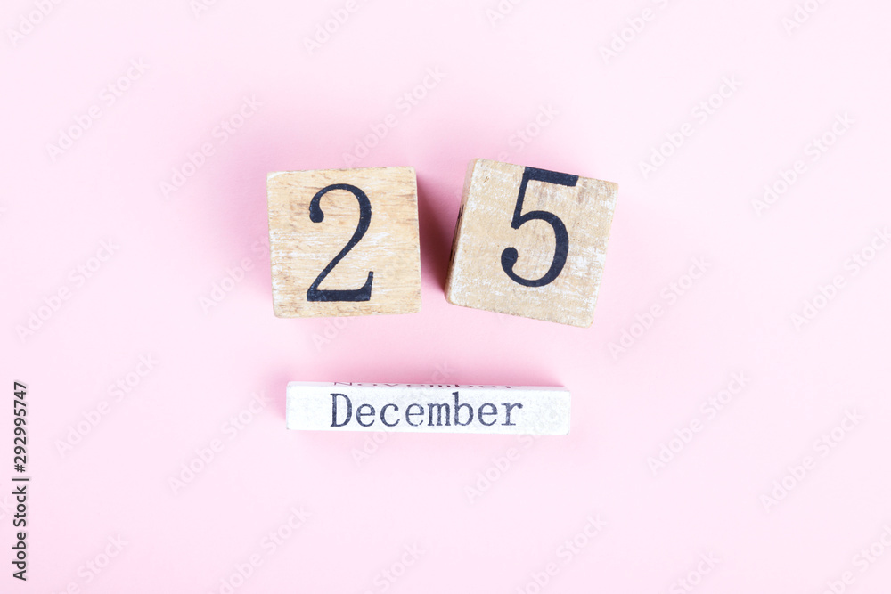 Wooden block calendar 25th December on a pink background. Happy Christmas holiday celebration concept, Copy space your text Wooden block calendar 25th December on a pink background. Happy Christmas holiday celebration concept, Copy space your text