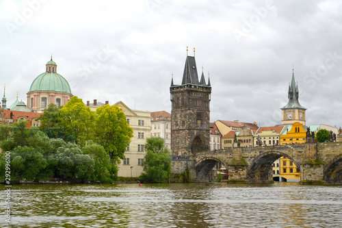 Bridge tower and fragment of Karlov Bridge through the Vltava River. Czech Republic, Prague