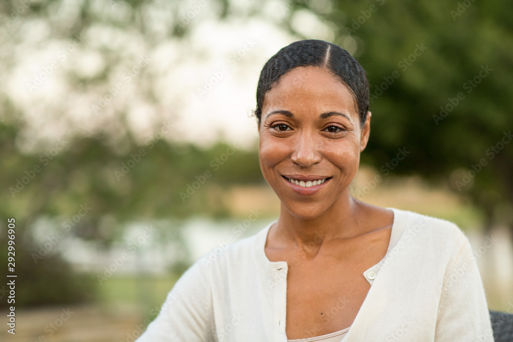 Mature confident African American woman smiling outside.