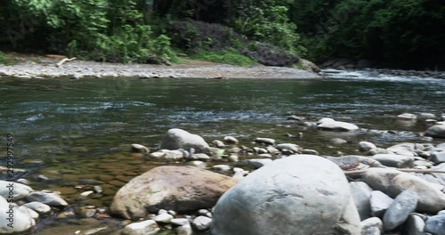 Stony bank of the river in the jungle. Large stones. Panorama along the river Bohorok. Bukit Lawang. photo