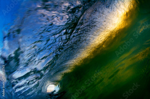Fototapeta Naklejka Na Ścianę i Meble -  Abstract background of an inside out view of a breaking wave with green and yellow tones