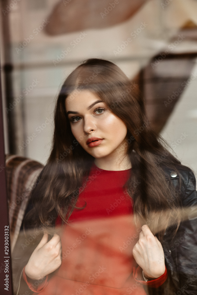 Portrait of beautiful woman, captured through the window glass Portrait of beautiful woman, captured through the window glass