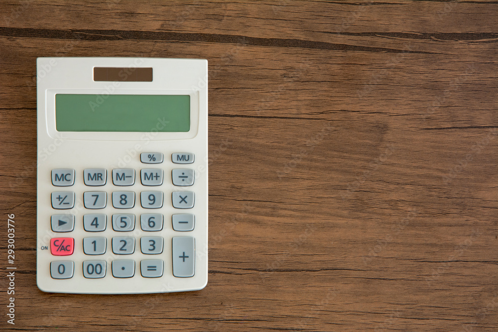 Calculator on wooden background Calculator on wooden background