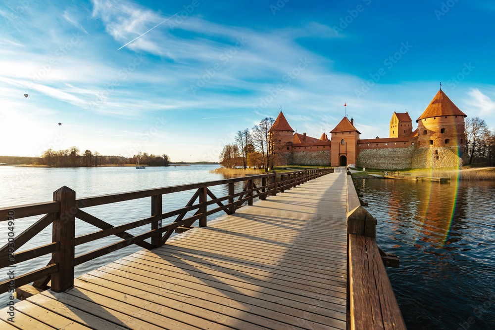 Wooden bridge to the Trakai castle in Lithuania during sunset. One of the most popular tourism objects in Lithuania.