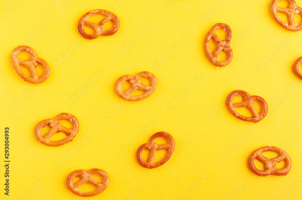 Traditional german pretzels on yellow Traditional german pretzels on yellow
