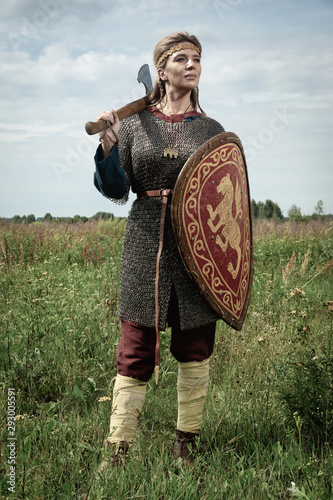 Viking girl warrior with axe in hand fighted.. photo