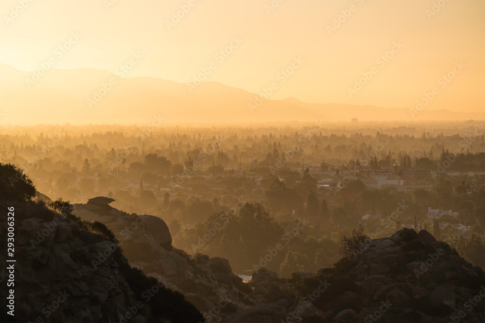 Hazy morning sunshine above West San Fernando Valley neighborhoods in the city of Los Angeles, California.  The San Gabriel Mountains are in the background.