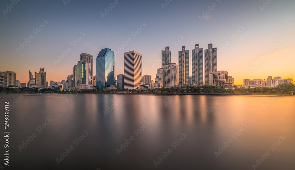 Skyscrapers Reflected in a Lake at Sunrise. Benjakiti Park in Bangkok, Thailand
