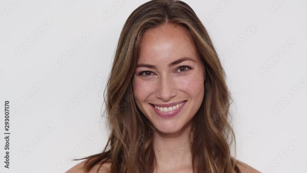 Closeup Shot of a Girl Smiling at the Camera, Wind Blowing her Long Brown Hair Closeup Shot of a Girl Smiling at the Camera, Wind Blowing her Long Brown Hair