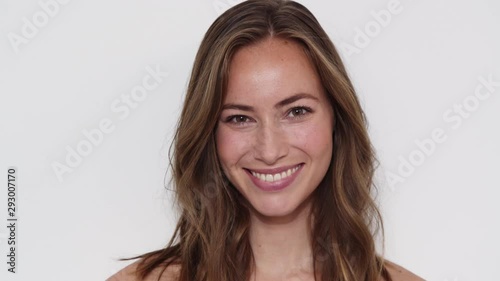 Closeup Shot of a Girl Smiling at the Camera, Wind Blowing her Long Brown Hair