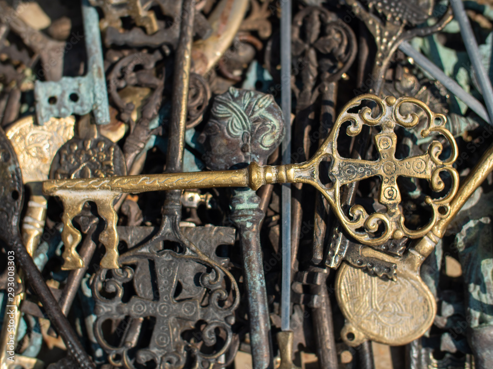 brass key on top of metal keys brass key on top of metal keys