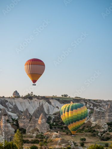 two hot air balloon tours rising over the Cappadocia desert