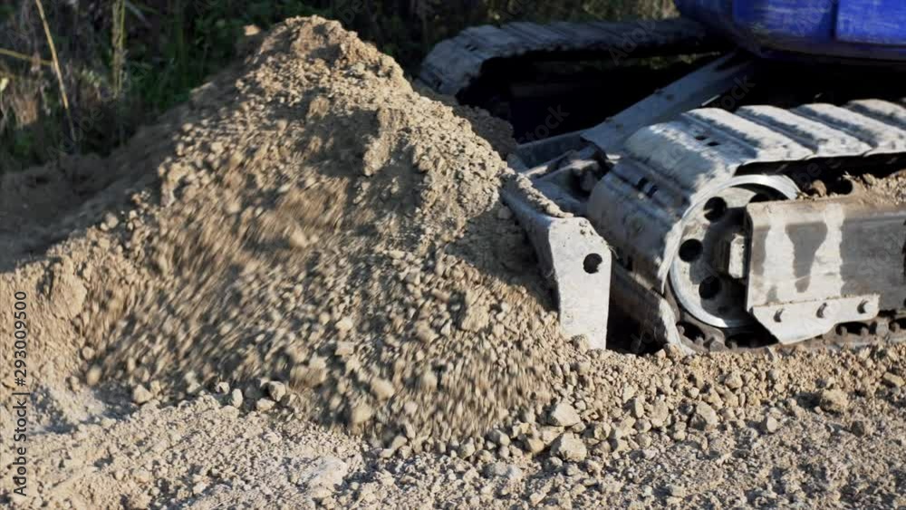 Powerful digger is working with soil