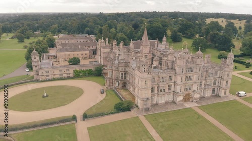 Aerial drone shot of Burghley House, a grand sixteenth-century country house, & surrounding countryside in England photo