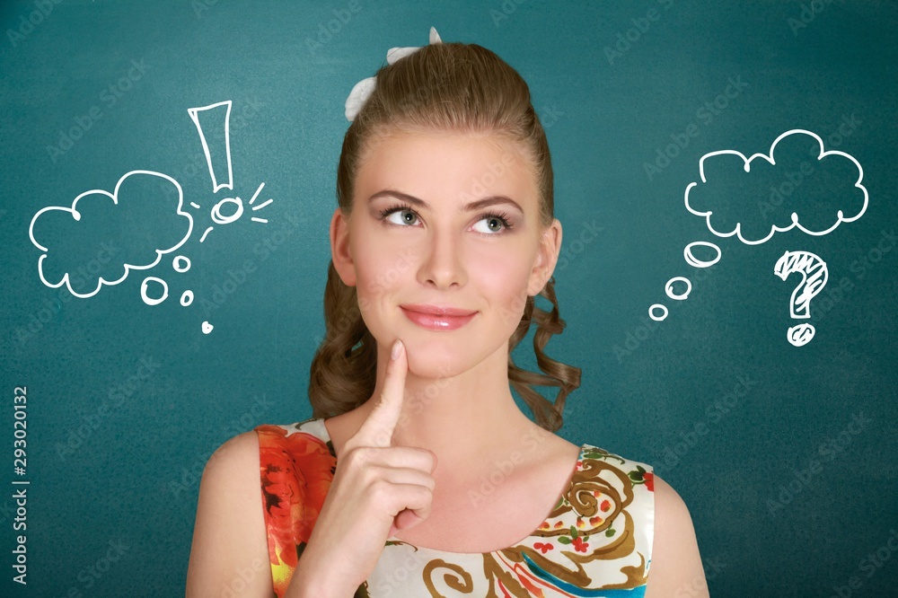 Portrait of thoughtful young woman on green background with signs Portrait of thoughtful young woman on green background with signs