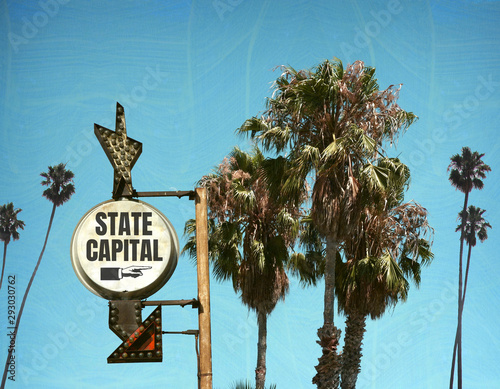 Aged and worn state capital sign with palm trees