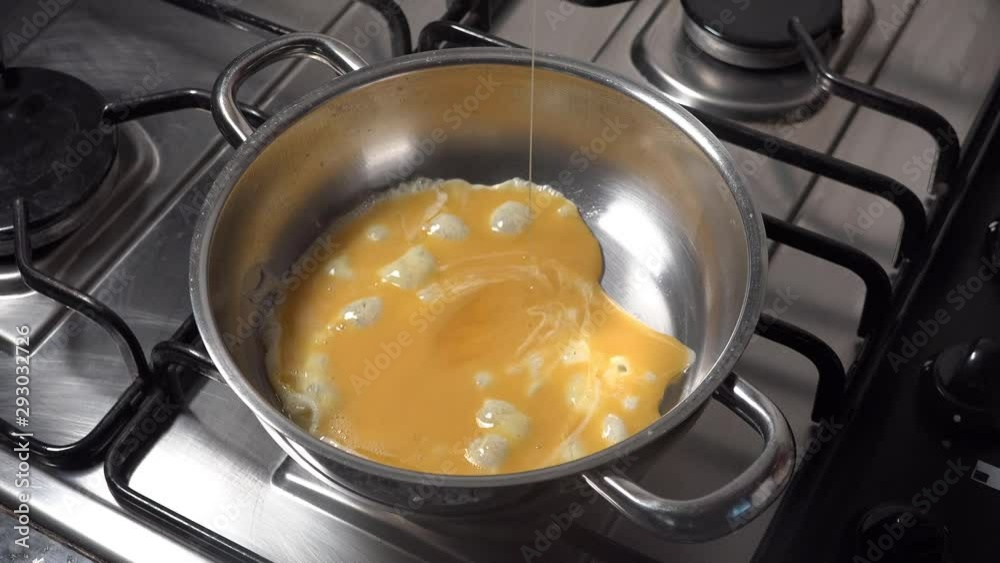 Pouring scrambled egg to hot steel pan