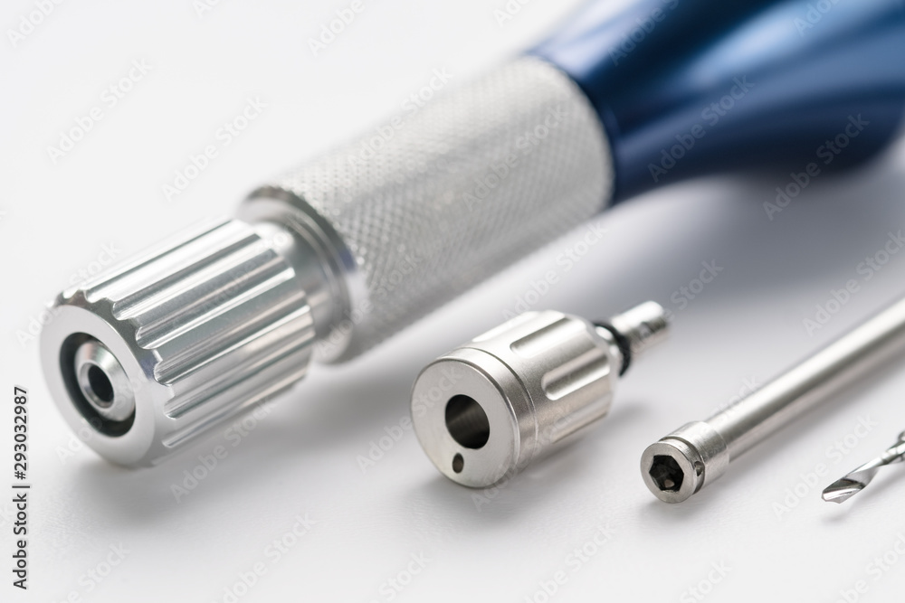 Closeup/ Implant surgical kits/ mini screw/ screw driver/ drilling bits on white background. Closeup/ Implant surgical kits/ mini screw/ screw driver/ drilling bits on white background.