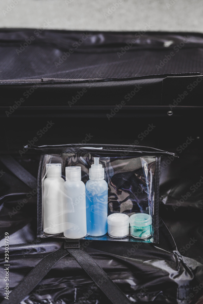 packing for a flight, transparent bag with small lotions for liquids