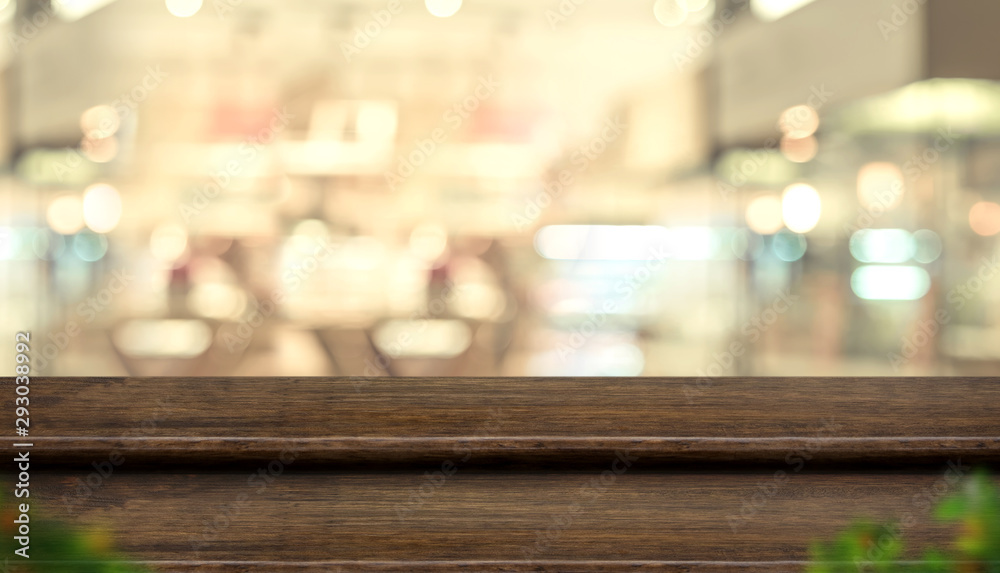 Empty step dark wood table top food stand with blur people in coffee shop background bokeh light.Mock up for display or montage of product,Banner for advertise on online media,business presentation