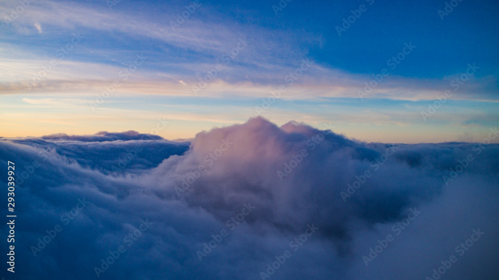 Magical view of cumulus clouds in winter at sunset