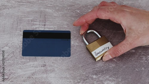 senstive payment data security online, hand locking security lock next to credit card photo