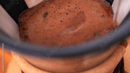 Kemex, pouring water on coffee, extreme close up. photo