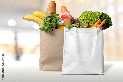 Shopping bags with groceries isolated on white background