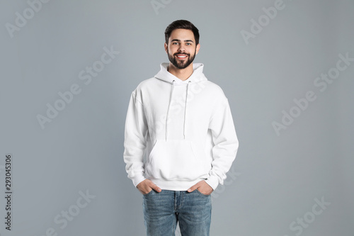 Portrait of young man in sweater on grey background. Mock up for design photo
