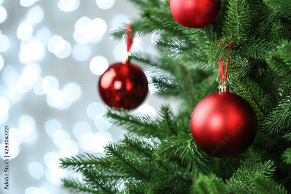 Decorated Christmas tree against blurred lights on background. Bokeh effect Decorated Christmas tree against blurred lights on background. Bokeh effect
