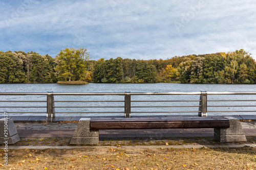 city river embankment in autumn season. urban landscape. autumn city park photo