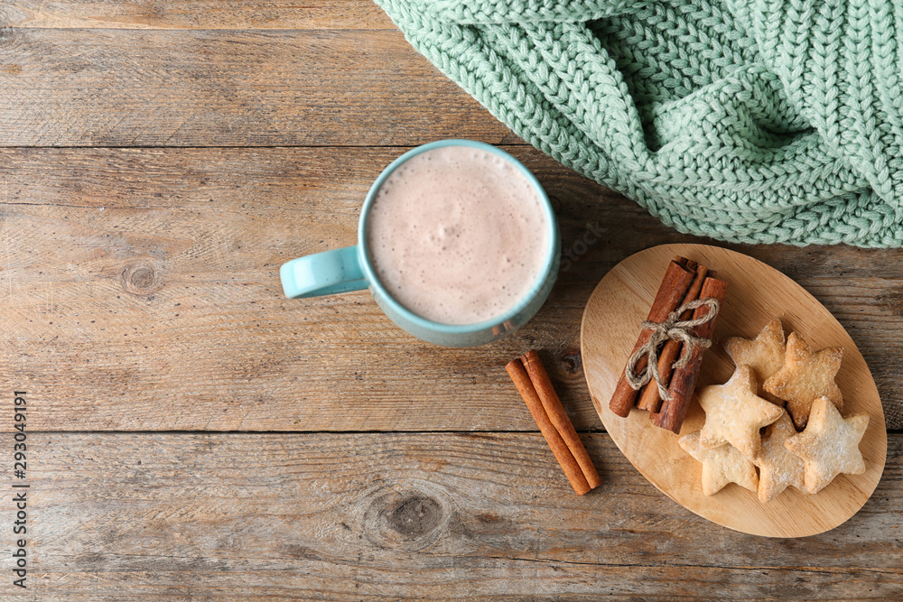 Fototapeta premium Composition with delicious hot cocoa drink and cookies on wooden background, flat lay