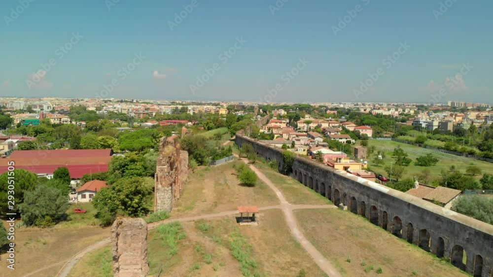 AERIAL DOLLY IN: Drone flying towards Rome (Italy) while passing over an ancient roman aqueduct, during the afternoon on a hot summer day AERIAL DOLLY IN: Drone flying towards Rome (Italy) while passing over an ancient roman aqueduct, during the afternoon on a hot summer day