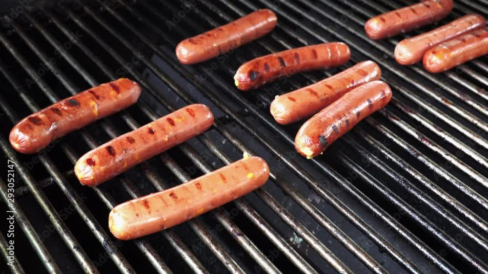 Hotdogs on a grill at a summer cookout. Hotdogs on a grill at a summer cookout.