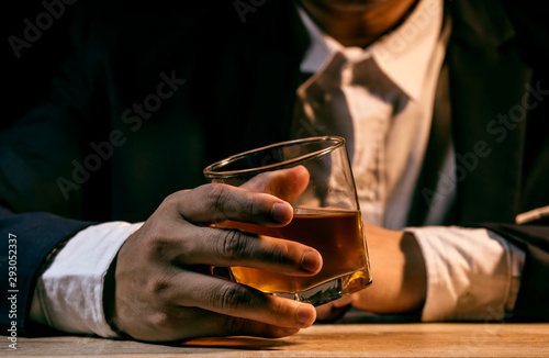 Closeup businessmen holding a glass of whiskey 