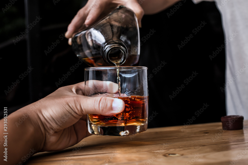 Bartender Serve Whiskey, on wood bar Bartender Serve Whiskey, on wood bar