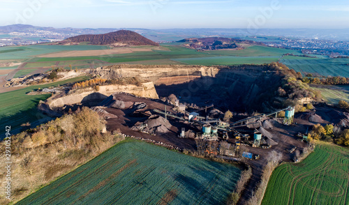 Aerial view of machinery in open gravel pit mining. Processing plant for crushed stone and gravel. Mining equipment