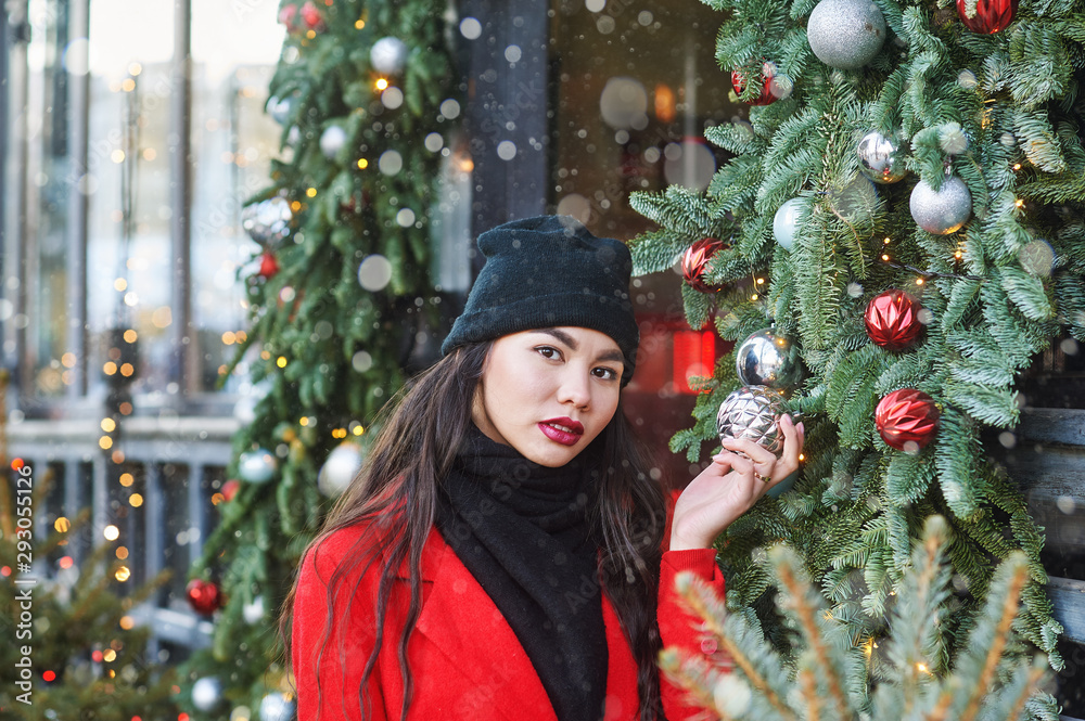 Young girl on a walk on a winter day in the city during Christmas holidays Young girl on a walk on a winter day in the city during Christmas holidays