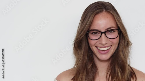 Woman with Brown Eyes Entering the Frame, Smiles and then Walks Out