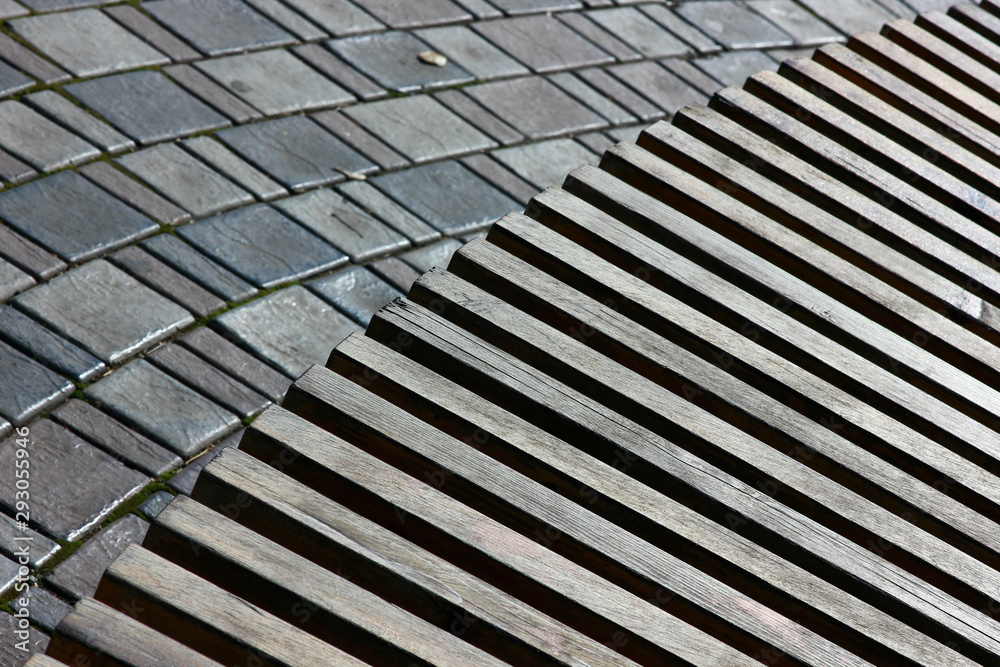 relief structure of a wooden bench in combination with decorative paving relief structure of a wooden bench in combination with decorative paving