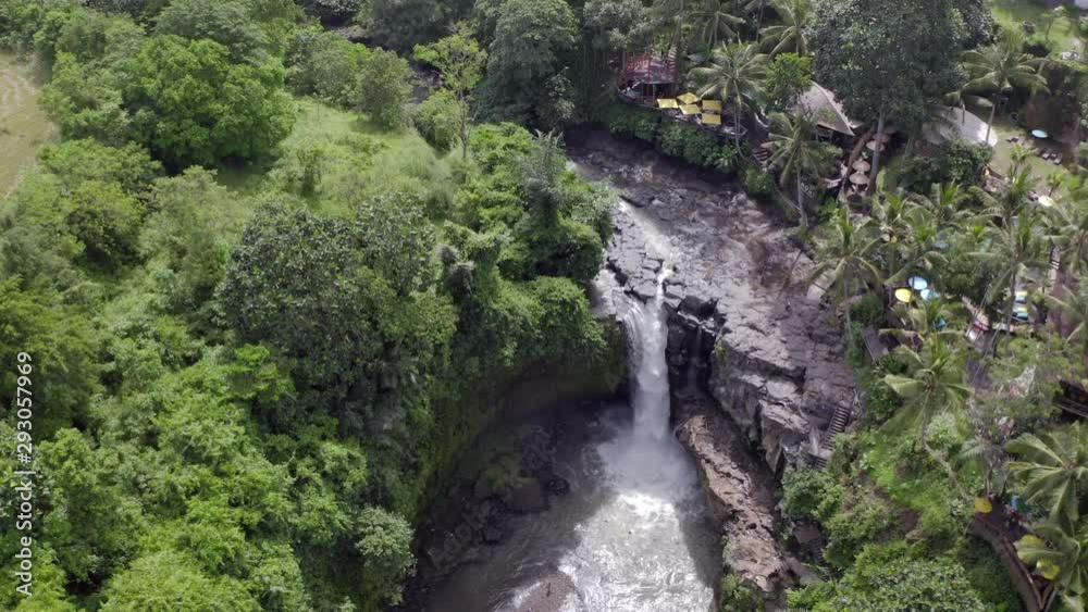 Aerial: Beautiful Tegenungan Waterfall amidst green trees and plants - Bali, Indonesia Aerial: Beautiful Tegenungan Waterfall amidst green trees and plants - Bali, Indonesia