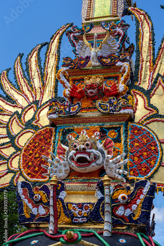 Bade cremation tower with traditional balinese sculptures of demons and flowers on central street in Ubud, Island Bali, Indonesia . Prepared for an upcoming cremation ceremony